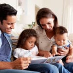 Photo of hispanic family reading a book